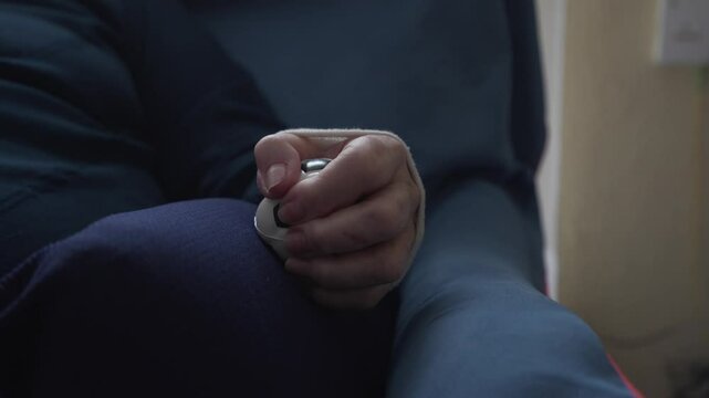 video detail of wrist-injured elderly woman's hand squeezing stress ball