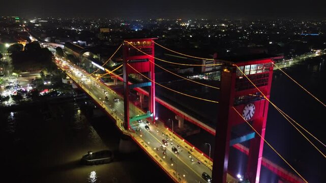 Aerial shot of Ampera Bridge at night, one of the landmarks of Palembang city, South Sumatra, Indonesia