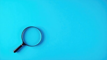 Magnifier resting on a blue background in close-up.