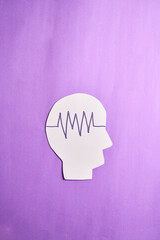 International Epilepsy Day, seizure disorder. Head papercut with stroke waves