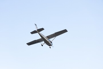 Single engine ultralight aircraft flying in the sky. empty space for insertion.