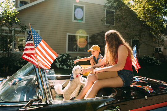 Children and dog in car in Fourth of July Parade
