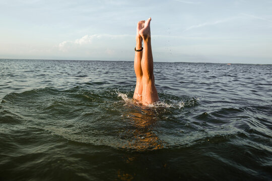 Girl doing handstand in the lake