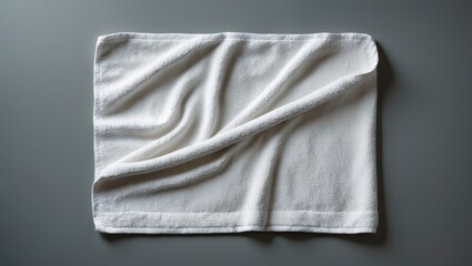 Fototapeta premium White towel mockup template made of cotton fabric for a wiper, isolated on a background with clipping path, flat lay top view for hand towel and face cloth template.