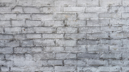 Old dirty brick wall with white plaster, close-up