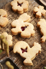 Linzer cookie in the shape of Easter bunny and rooster filled with strawberry marmalade