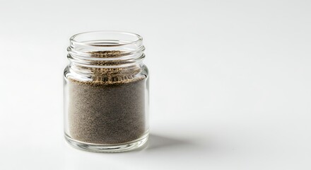 Elegant presentation of black peppercorns in a modern glass jar on white background