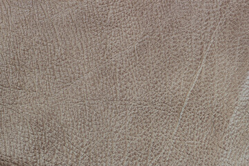 Texture of genuine leather with wrinkles and cracks. Brown leather texture with detailed natural patterns. Organic surface with fine wrinkles cracks, aged background for design, fashion, upholstery