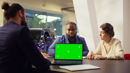 Dealership salesman looking over appointment list on chroma key laptop spreadsheet to schedule car test drive. Showroom agent arranging meeting with clients using isolated screen notebook, camera B