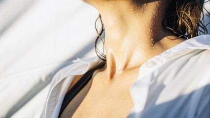 a close-up shot of a person neck and shoulder, with a white shirt and wet skin, exudes a sense of freshness and sensuality