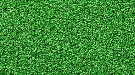Fototapeta premium A closeup view of lush synthetic grass, showcasing its rich green color and fine texture, perfect for sports fields.