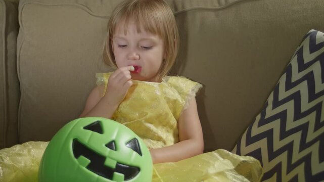 Little Girl Enjoying Halloween Candy Closeup
