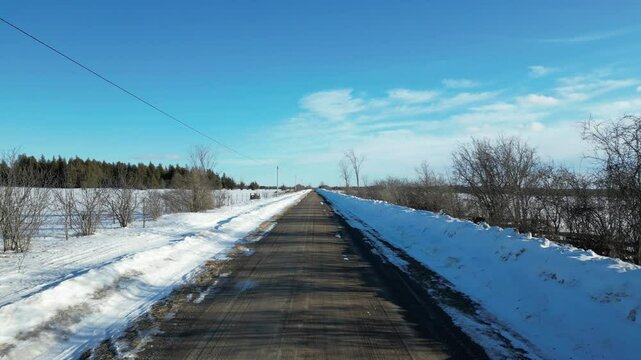 Low-level flight on a country road in a snow-covered landscape - Vol &agrave; basse altitude sur une Route de campagne dans un paysage enneig&eacute;