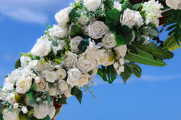 close-up of a floral arbor isolated against a blue sky. weddings and celebrations background...