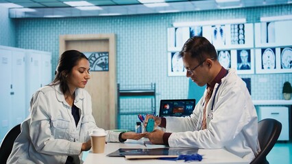 Indian physician prepares insulin pen for patient injection during a clinic visit, treating diabetes. Medic discusses disease diagnostic reports in a professional cabinet, gives advice. Camera B.