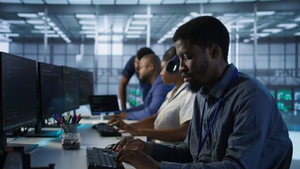 Focus on server hub employee developing disaster recovery plans ensuring minimal downtime. African...