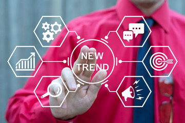 Business person using virtual touch screen push inscription: NEW TREND. Trends Business Marketing Technology Internet Network concept. Conceptual new trend and goals start up.