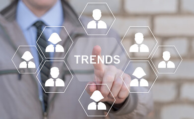 Business person using virtual touch screen push word: TRENDS. New trend. Trends Business Marketing...