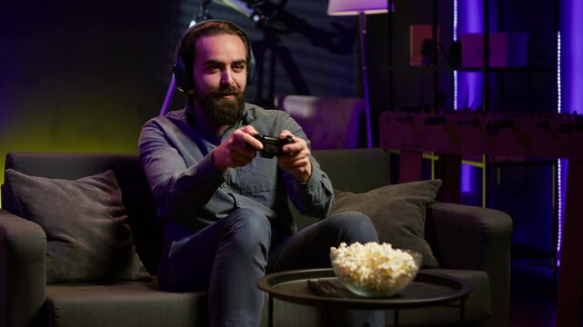 Satisfied gamer bragging after finally defeating all enemies while playing on gaming console. Pleased player congratulating himself after winning videogame using controller, camera A