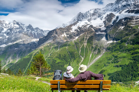 Switzerland Travel - Senior Couple enjoy the Scenic view of the snowcapped mountains in the Jungfrau region of Lauterbrunnen  Swiss Alps
