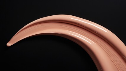 Fototapeta premium Cosmetic smudge swatch of brown concealer sculptor set against a black background.