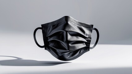 Blank black cotton reusable cloth mask on a white background. Front view. Empty surgical mask for mockup. Clear protective face mask for branding and template.