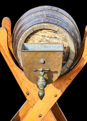 A vintage wooden beer keg with a metal tap and spigot on a rustic stand, ideal for traditional pub or brewery settings and craft beer enthusiasts