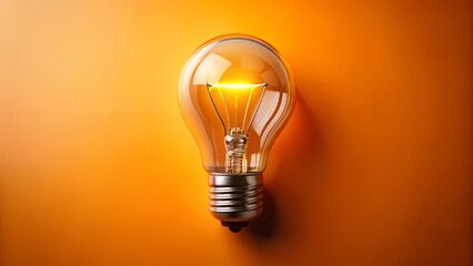 A single incandescent lightbulb illuminates brightly against a smooth, vibrant orange backdrop.