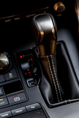 Inside the car.Gear shift handle in a modern car.Vehicle interior.Dashboard, inner workings of a...