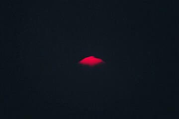 Black white sky with only a single glowing pink sunset cloud adding warmth