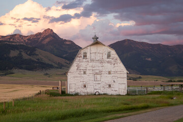 Rustic Barn in Bozeman, Montana with Vibrant Sunset and Mountain Backdrop