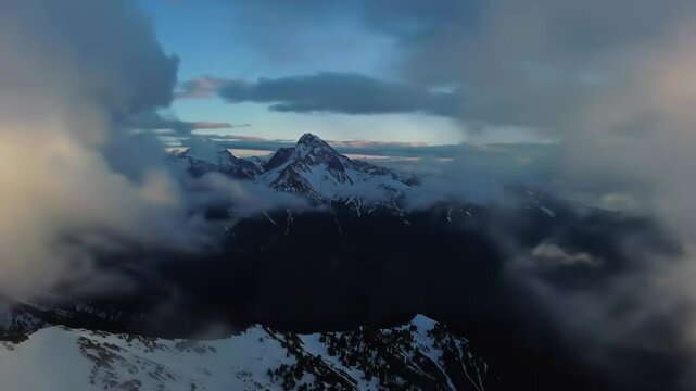 Clouds Rolling Over Mountains &ndash; A dramatic view of clouds forming, moving, and dissipating over peaks