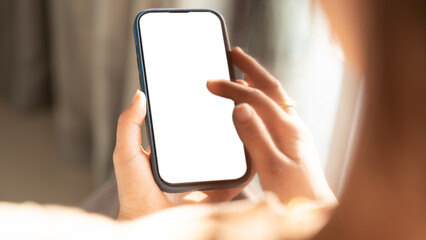 Close up of Woman hand holding using touch mobile phone white screen mockup. Back view