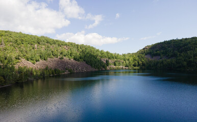 Fototapeta premium Aerial view of Bean and Bear Lakes in Silver Bay, Minnesota, surrounded by lush forests.