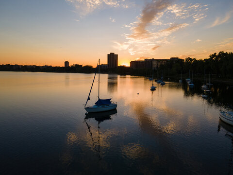 Sailboats floating on calm lake at sunset in Minnesota