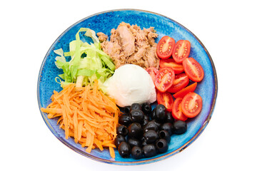 Salad with Buffalo mozzarella, tuna fish, cherry tomatoes, iceberg salad, olives, carrots,  in the blue plate with white background