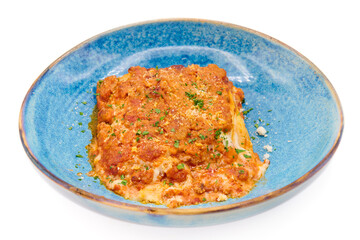 Traditional italian dish lasagna alla bolognese in the blue plate with white background