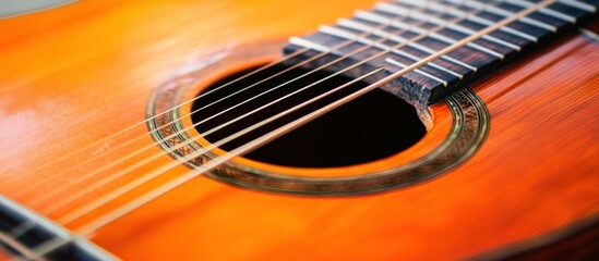 Obraz premium Detail of an acoustic guitar, capturing wood grain and string resonance