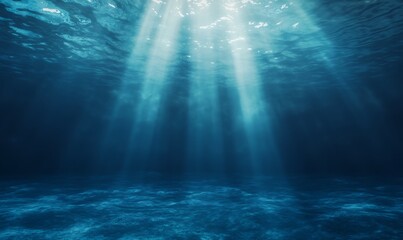 Obraz premium Underwater scene with light rays illuminating the deep blue ocean atmosphere.