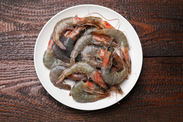 Fresh raw shrimps on wooden table, top view