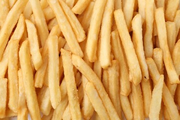 Pile of delicious French fries as background, top view