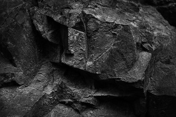Black white dark stone rock granite background. Mountain surface texture. Close-up. For design.