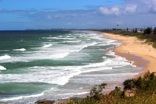 Drone view of the ocean with many waves on a sunny day