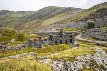 Near Blaenau Ffestiniog, Gwynedd. Llyn Cwmorthin with the ruin of Cwmorthin Terrace, the Compressor House and the quarry in the background