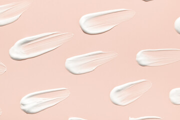 A white pristine smear on solid color background,  Creamy skincare product swatch 