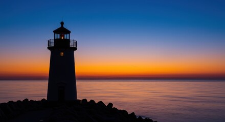Lighthouse stands tall against a vibrant sunset