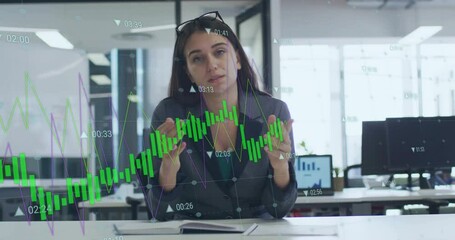 Businesswoman in office with financial graph animation overlaying her image