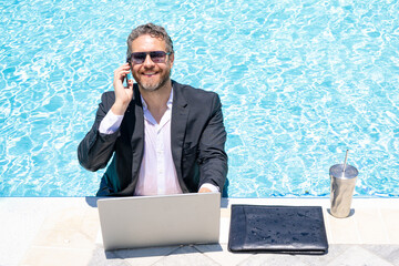 Summer business. Business success. Funny office worker online work, e-working. Summer businessman in suit with laptop in sea pool water. Hot business. Funny summer. Crazy business travel.