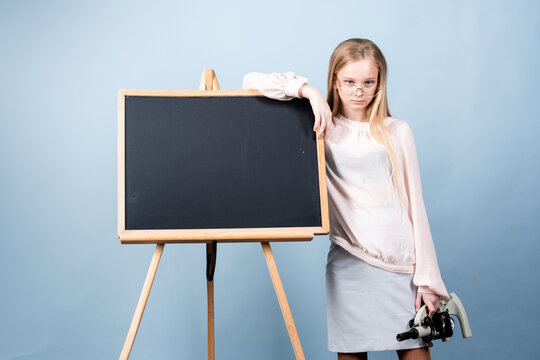 Schoolgirl near blackboard. School and students in classroom. Education kids. Child pupil student in the school class. Studying and learning concept.