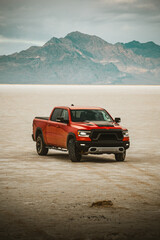 Off-Road Adventure Concept: Red Pickup Truck in a Rugged Desert Landscape © Victoria Nefedova